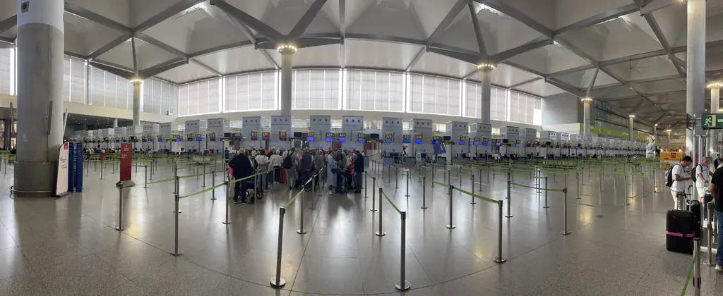 Row of check-in desks with queue barriers in the Málaga Airport departures hall